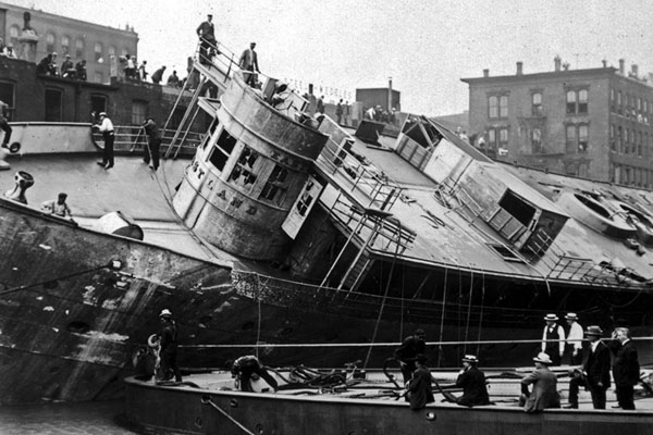 The Eastland ship being righted after the Eastland Disaster on the Chicago River, 1915.