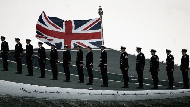 PORTSMOUTH, UNITED KINGDOM - JUNE 28: Sailors on board the aircraft carrier HMS Illustrious wait on the flight deck to salute during The International Fleet Review on June 28, 2005 in Portsmouth, England. The Review forms part of the Trafalgar 200 celebrations marking the 200th anniversary of the Battle of Trafalgar at which Lord Nelson commanded the Royal Navy in a famous victory over the French. (Photo by Peter Macdiarmid/Getty Images)